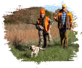 Hunters walking in a field